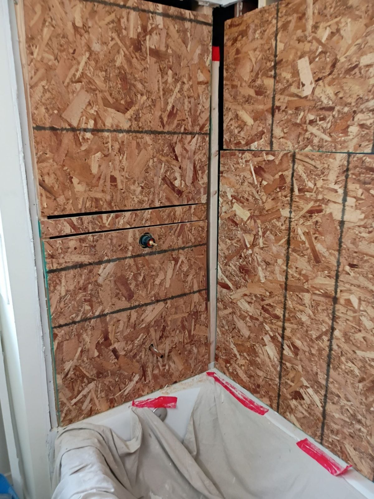 Bathroom demolished down to the sheathing ahead of a rebuild in Pittsburgh, PA