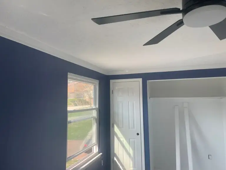 Bedroom repainted with a navy accent wall in Pittsburgh, PA