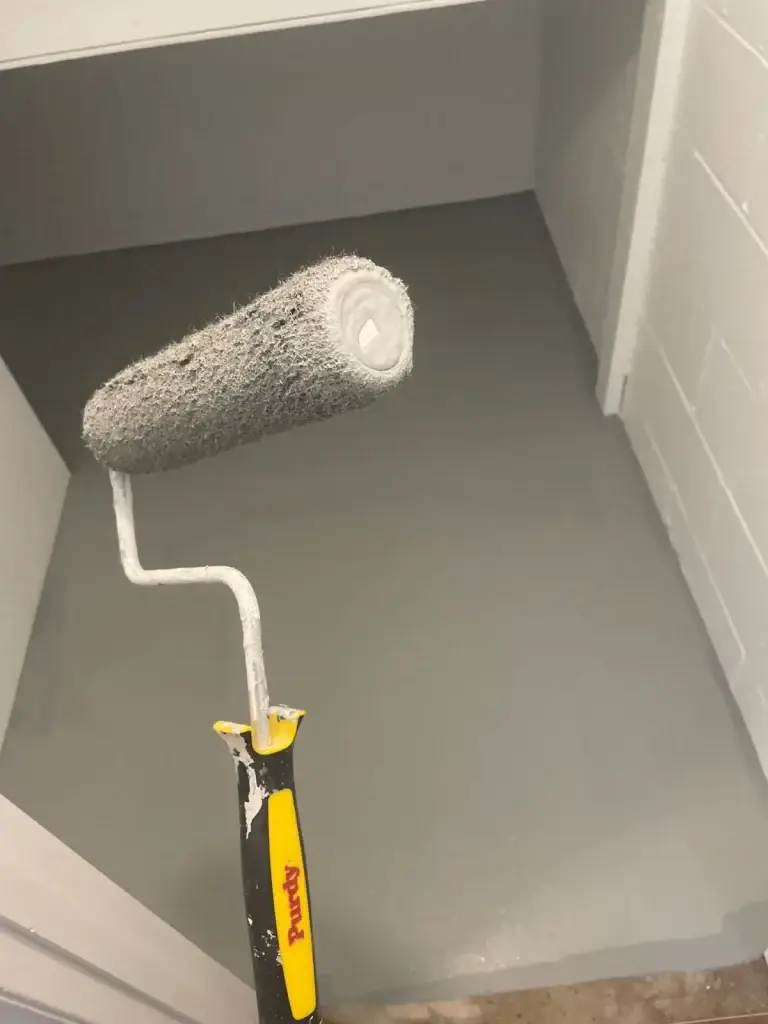 Rolling fresh paint on interior walls in Pittsburgh, PA