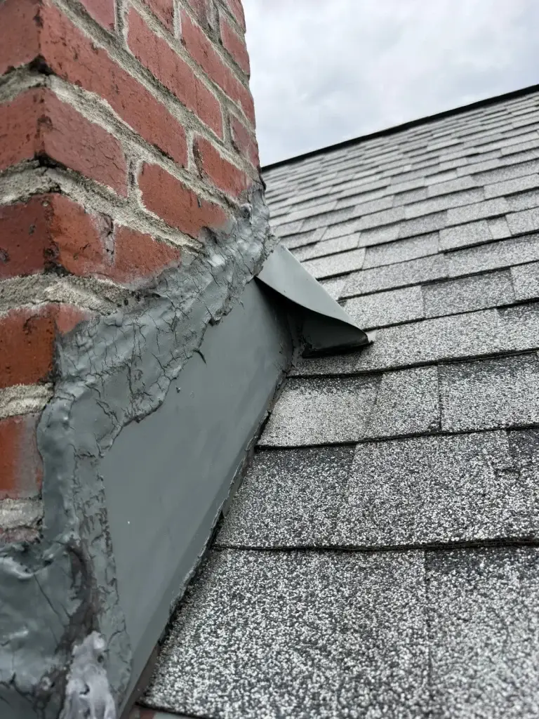 Roof flashing repair along a brick wall in Pittsburgh, PA
